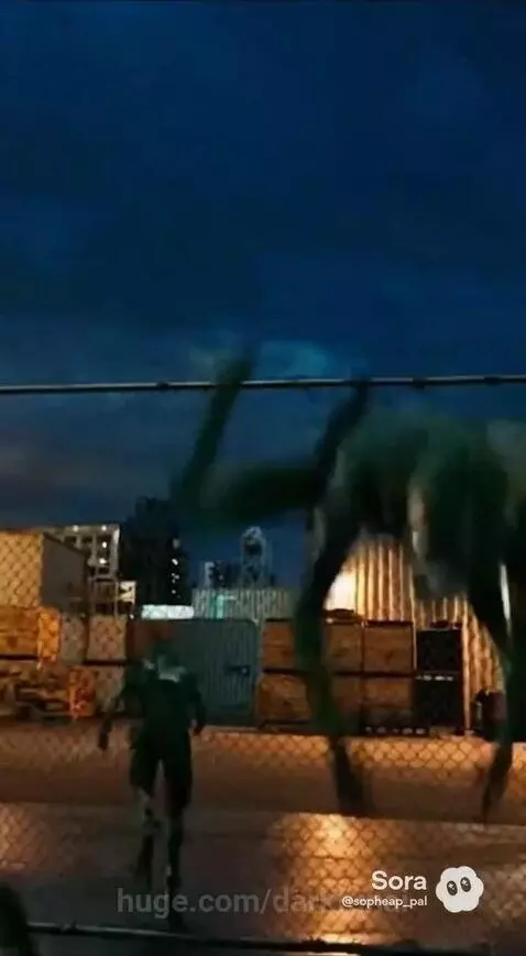 Police officers in 'POLICE ICE' uniforms chase alien creatures across a city rooftop at night.