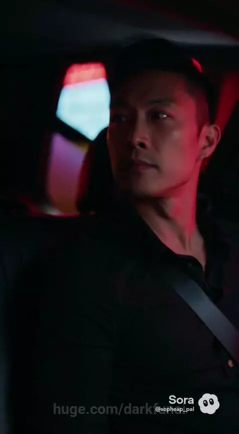 Yellow taxi driving at night on a neon-lit city street with palm trees and tall buildings.