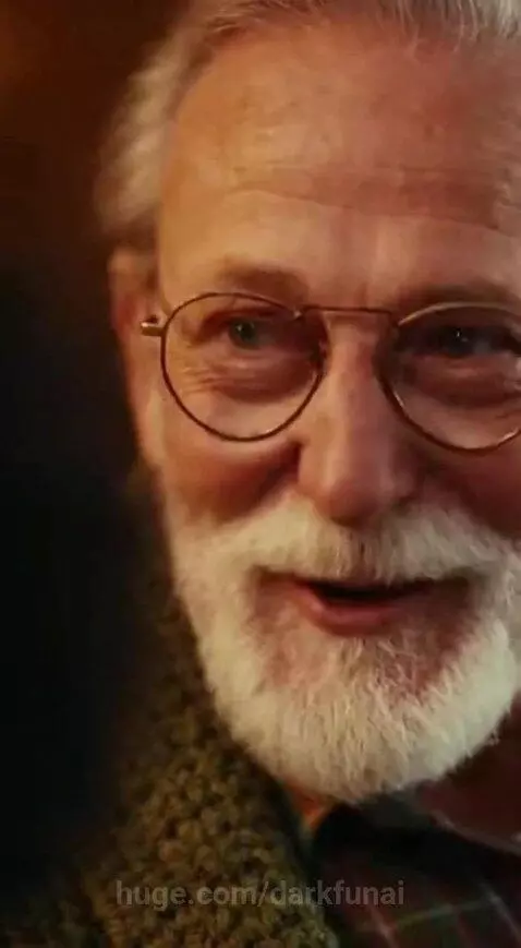 Young boy looking surprised at an older man who is smiling and talking.