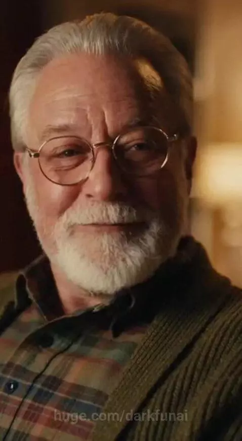 Older man with white beard and glasses teaching a young boy about Morse code with a telegraph key.