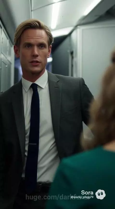 Man in a suit offers a woman a black card with the number 4 on it, implying a tuition payment offer.