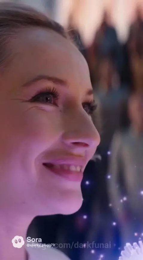 A man and woman in white gowns share an intimate moment with glowing flowers in a grand, futuristic hall.