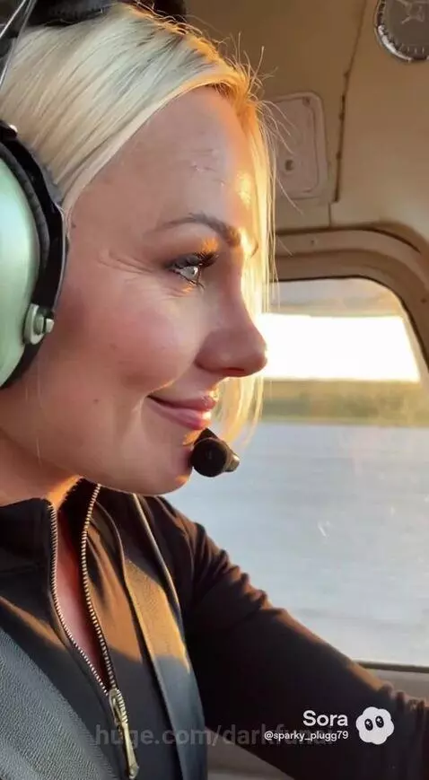 Woman in cockpit of small plane at sunset over the Everglades