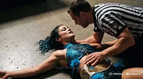 Wrestling referee kissing a woman in a blue sequined outfit with a championship belt.