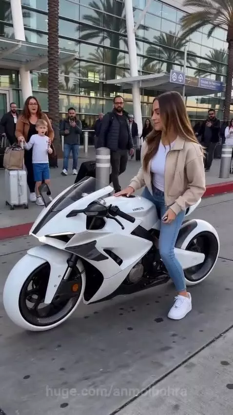Woman riding a white motorcycle that transforms into a suitcase at an airport terminal.
