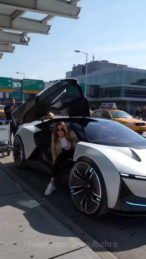 Futuristic white car with blue accents transforming into a suitcase at an airport curb.