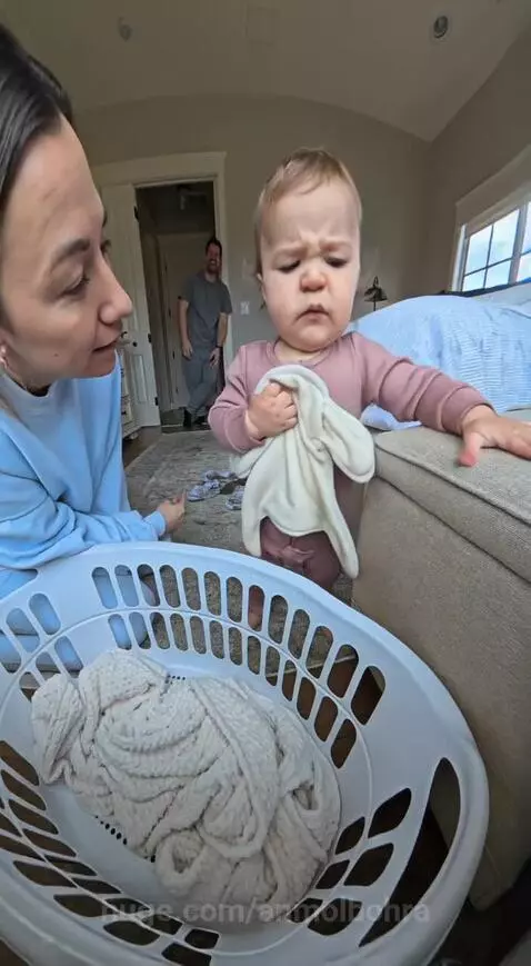 Baby points at dad's socks on the floor, demanding they be washed before her blanket.