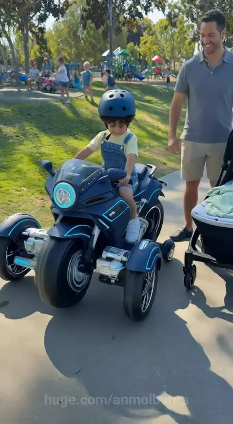 A family riding a futuristic hypertrike vehicle in a park, transformed from a child's toy motorcycle.