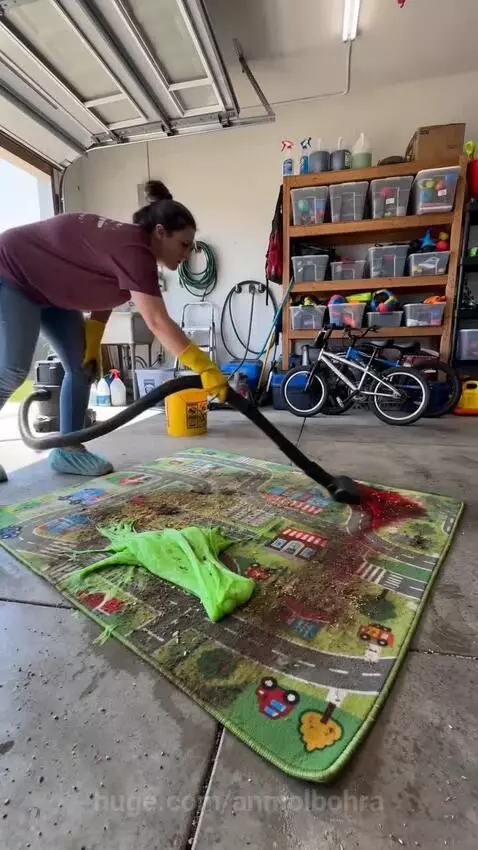 Woman in yellow gloves cleaning a dirty children's playmat with slime and dirt, leaving it spotless.