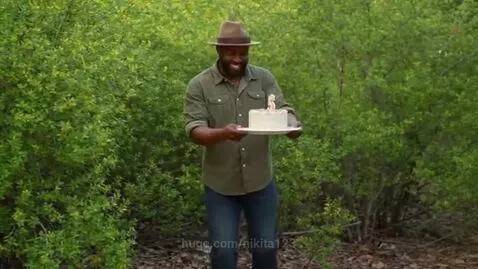 A dark-skinned man in a hat is dancing in the bushes with a ... by nikita123