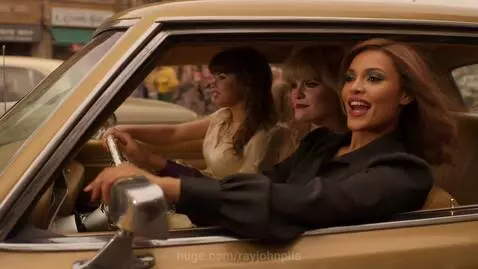 People in 1970s disco fashion dancing and enjoying themselves with classic cars and a disco club setting.