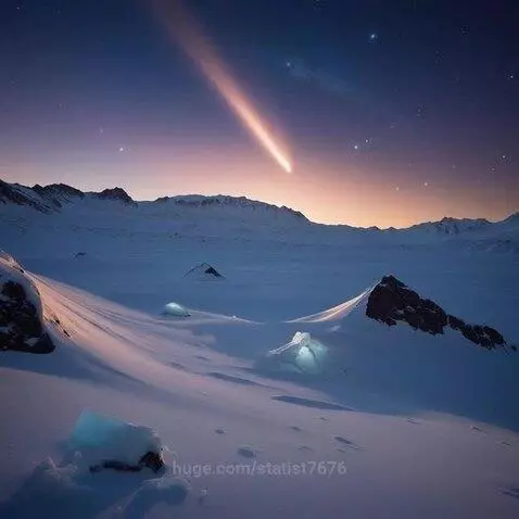 Snow-covered mountains at night with a bright comet streaking across the star-filled sky.
