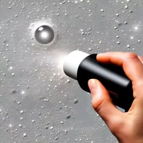 Close-up of white foam reacting and spreading on a textured grey surface with a reflective sphere.
