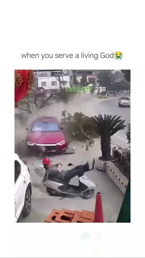 Person on a scooter narrowly escapes a car crash, appearing unharmed and pushing the car away.