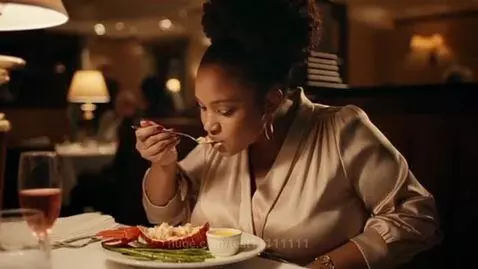 Woman eating lobster, chocolate cake, meat dish, and cheesecake in a restaurant, showing visible weight gain.