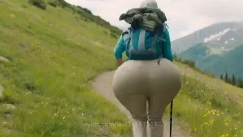 Woman hiking on a mountain trail as her hips and buttocks rapidly expand to an exaggerated size.
