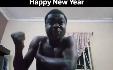 Shirtless man with dark skin celebrating New Year with facial gestures and arm movements.