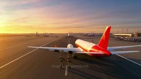Airplanes on airport tarmac during sunrise or sunset with a warm golden glow in the sky.