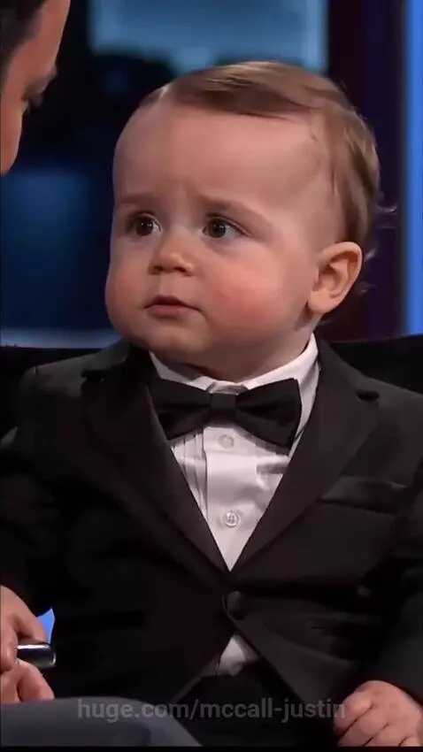 Baby in a tuxedo confidently answers interview questions about his flawless mommy.