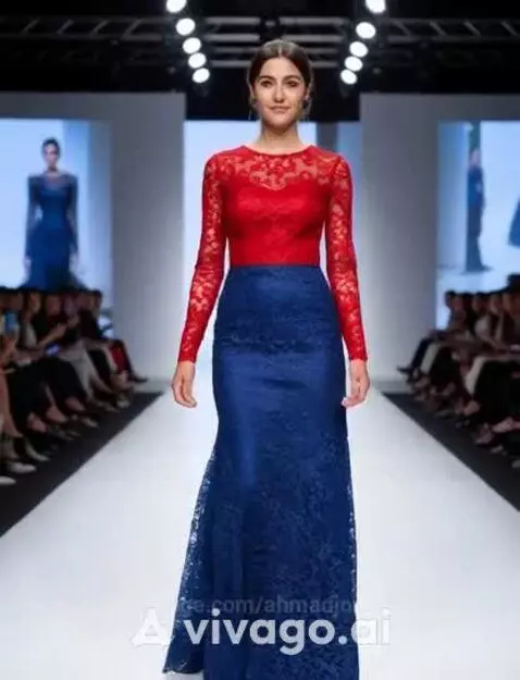 Fashion model in red lace top and blue lace skirt walks down a runway, audience in background.