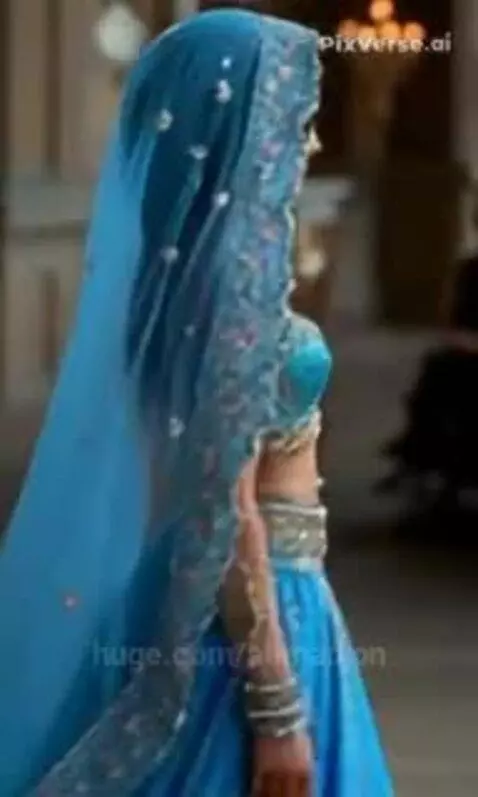 Woman in a detailed blue traditional Indian or Middle Eastern outfit with embroidered choli, lehenga, and dupatta.