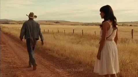 A cowboy walks away from a beautiful woman on the road by kabvit