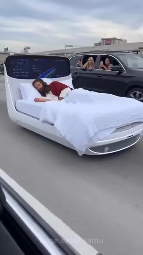 Man dressed as Jesus sleeping in a bed on a moving highway, filmed by women in an SUV.