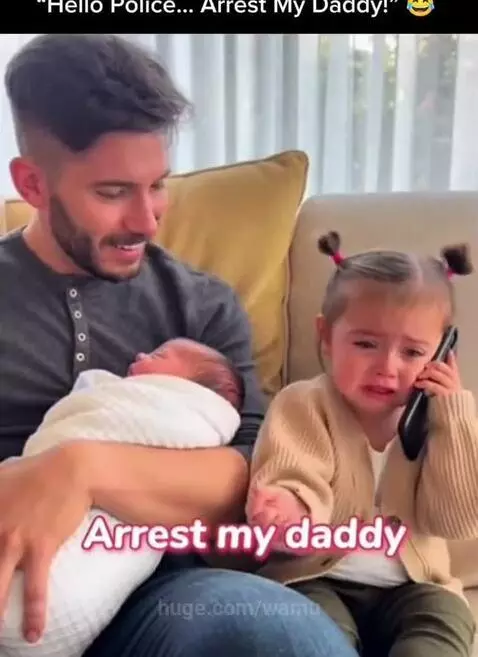 Upset young girl holding phone to ear, pretending to call police about her dad ignoring her for a new baby.