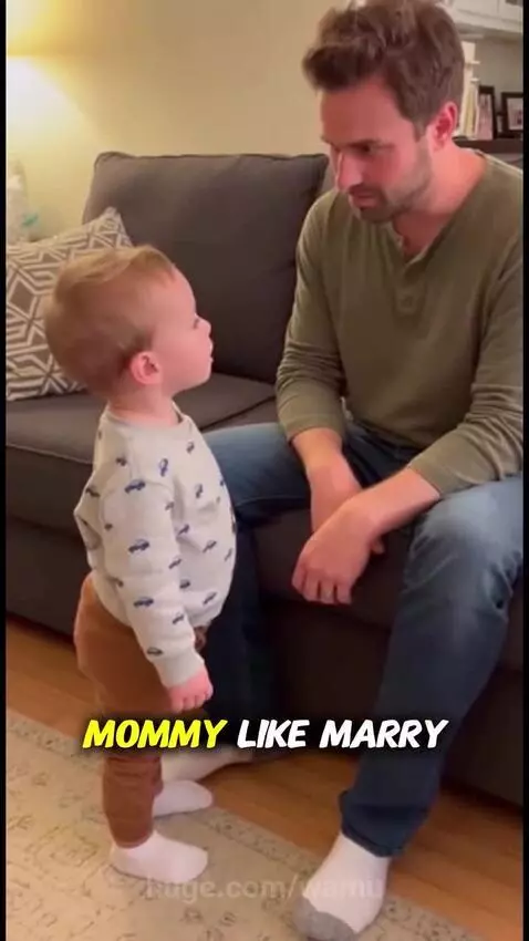 A young child looks at his dad sitting on a couch and makes a funny comment about his mom's marriage choice.