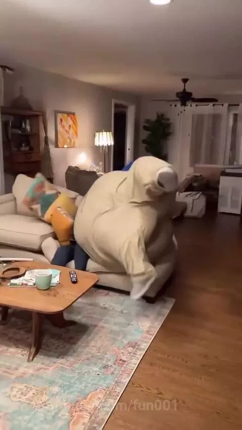 Man in a padded suit falls through a collapsing floor into a hole with smoke.