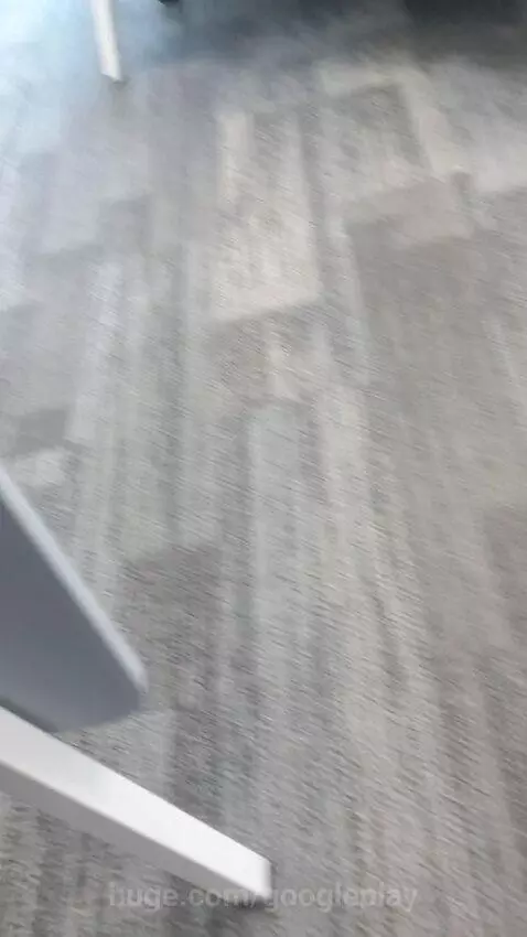 Blurry, fast-moving shot of a grey and brown textured surface, abstract and hypnotic.