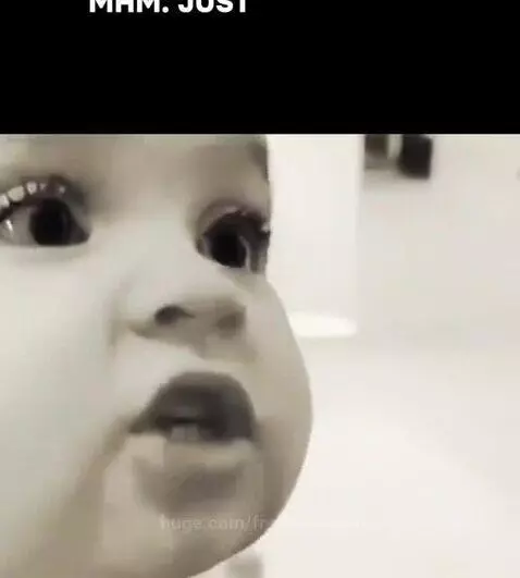 Close-up of a baby's face looking intently, as if giving serious advice.