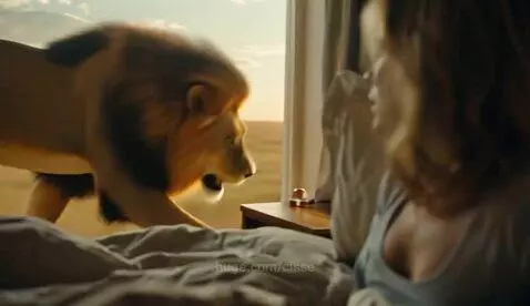 Woman waking up in terror from a dream about a lion at her window.