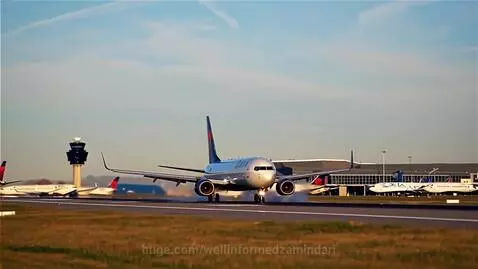 Delta airplane with blue and red tail markings landing on an airport runway, with ATC tower and other planes in background.