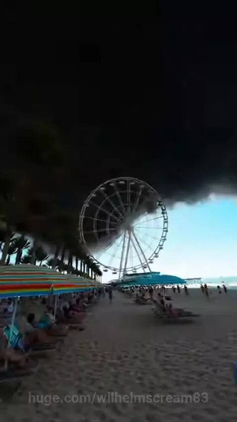 A sunny beach scene transitions to a collapsing Ferris wheel, then back to a clear beach with debris.