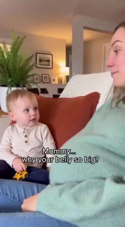 A young child looks at his pregnant mother's belly with confusion, asking if she ate the baby.