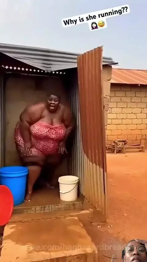 Woman in pink wrap screaming and running out of a small structure, a monkey on the roof.