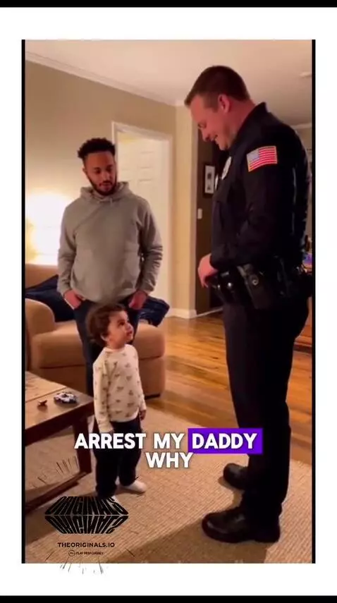 Child talking to a police officer, with dad smiling behind them.