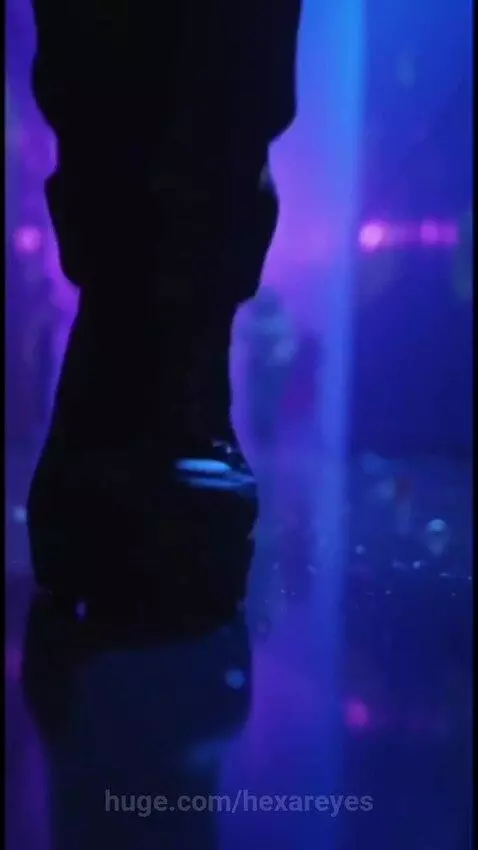 Frankenstein-like character Frank and Monro are chased by a shadowy monster in a neon-lit industrial environment.