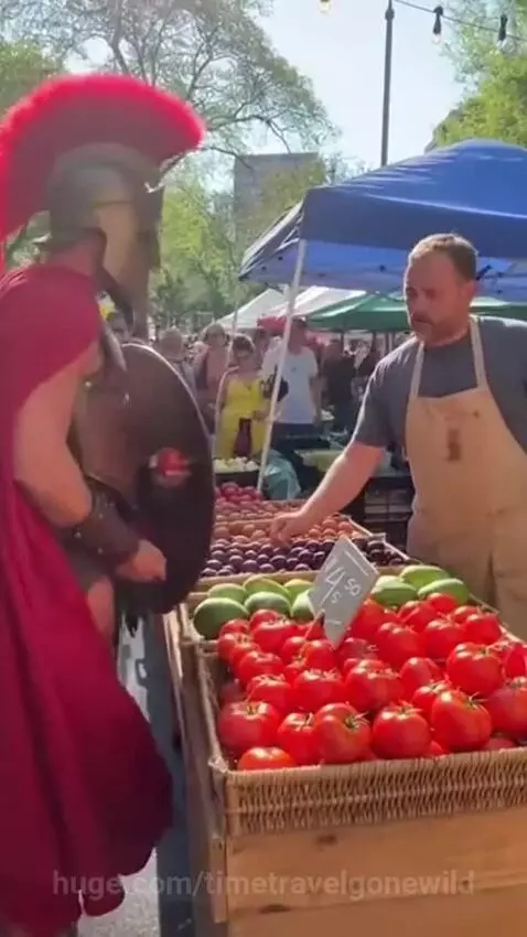 Spartan warrior in helmet and armor haggling with a fruit vendor at an outdoor market.