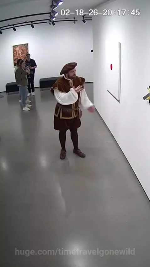 Man in Renaissance attire looking confused and frustrated at a modern art exhibit with a red dot painting.