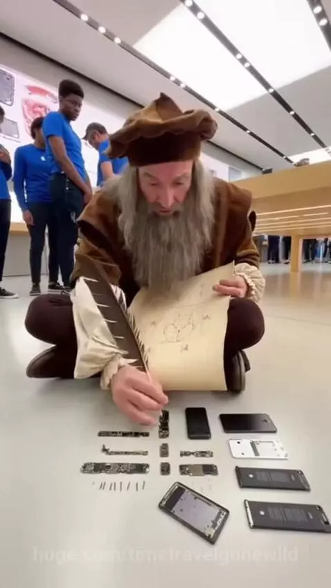 Man dressed as Leonardo da Vinci sketching disassembled iPhone parts on the floor of an Apple Store.