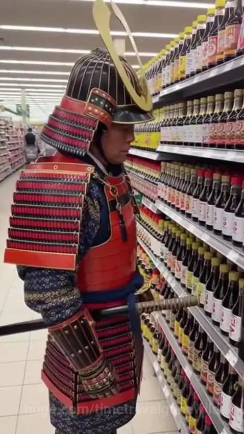 Samurai in traditional armor standing in a supermarket aisle, looking at shelves of soy sauce bottles.