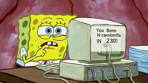 Spongebob Squarepants looking distressed while staring at an old computer monitor displaying a strange message.