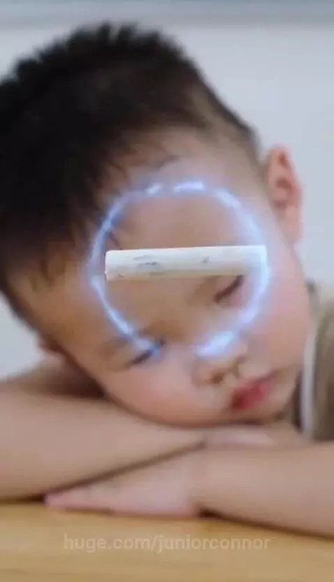 Boy with glowing blue eyes uses telekinesis to move chalk in a classroom.