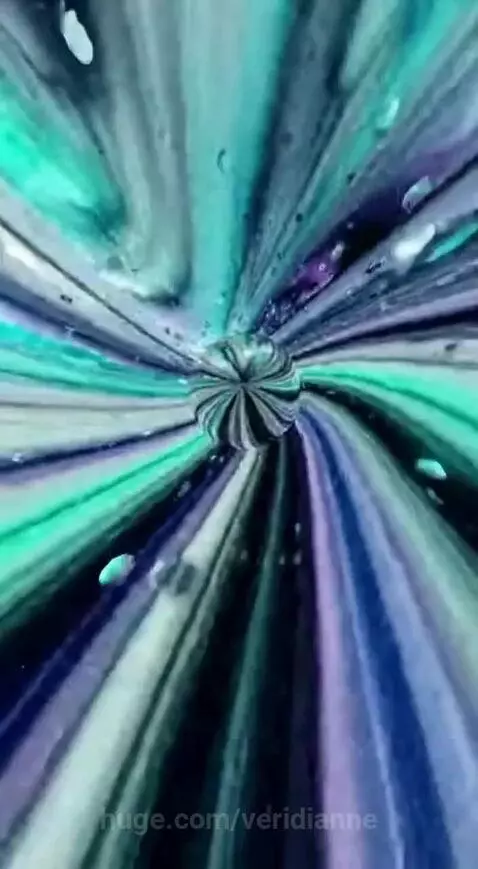 Abstract sphere with swirling blue, green, and purple colors, resembling liquid art or a digital kaleidoscope.