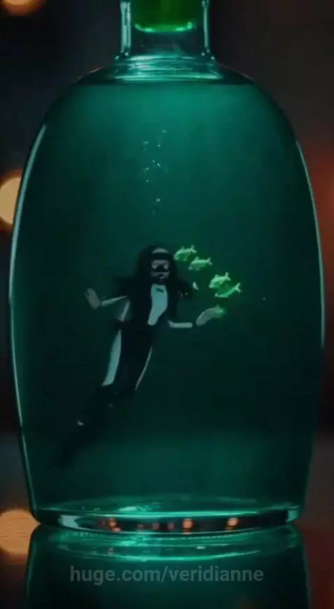 Miniature scuba diver in full gear meditating inside a glass bottle filled with glowing green liquid and small fish.