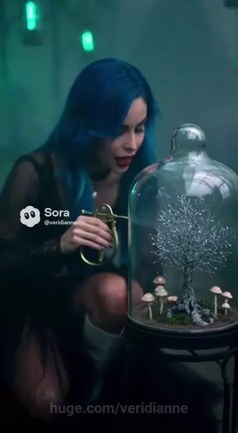Woman with blue hair in a black dress singing in a magical garden with glowing lanterns and a butterfly.
