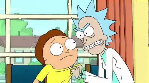 Rick Sanchez yelling and grabbing Morty Smith's shirt indoors, Morty looks scared.