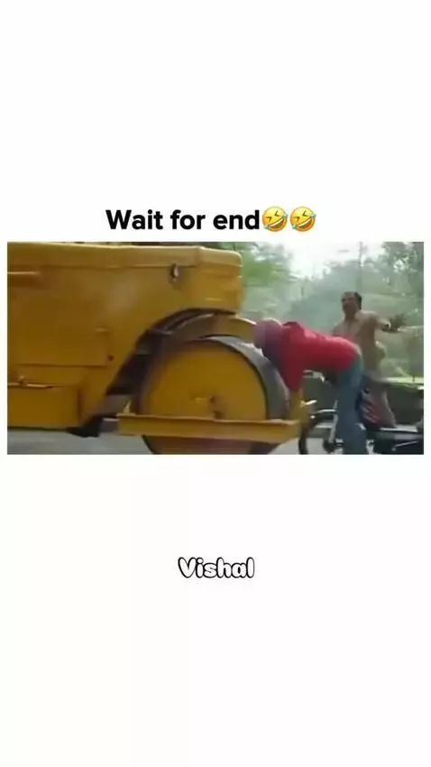 Man in red hoodie confronting a road roller driver after a comedic motorcycle prank.